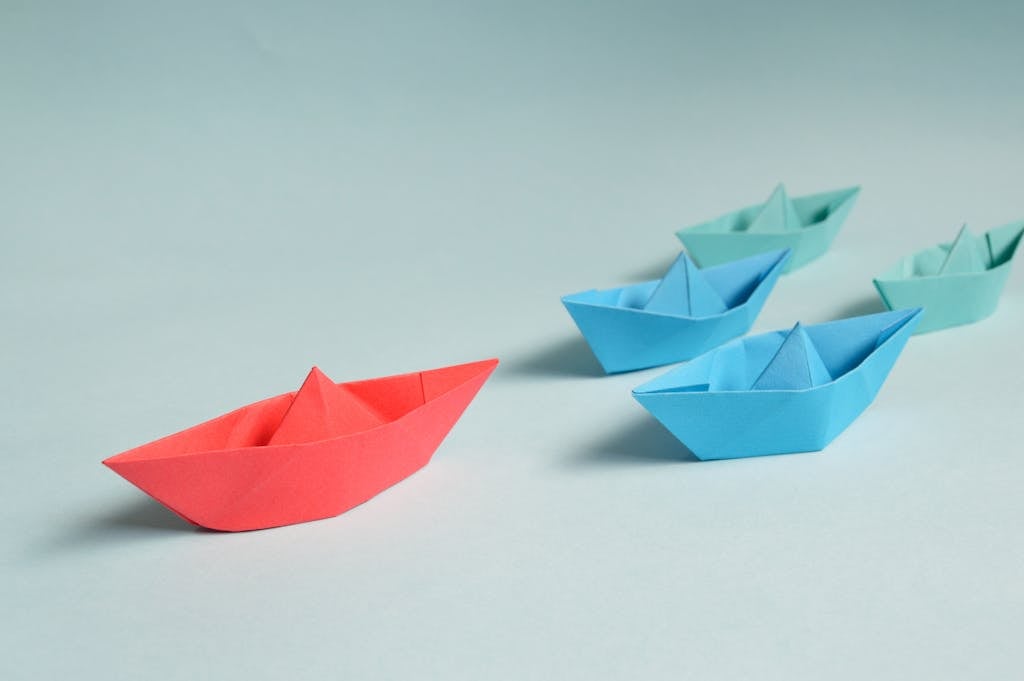 Paper Boats Leading Each Other