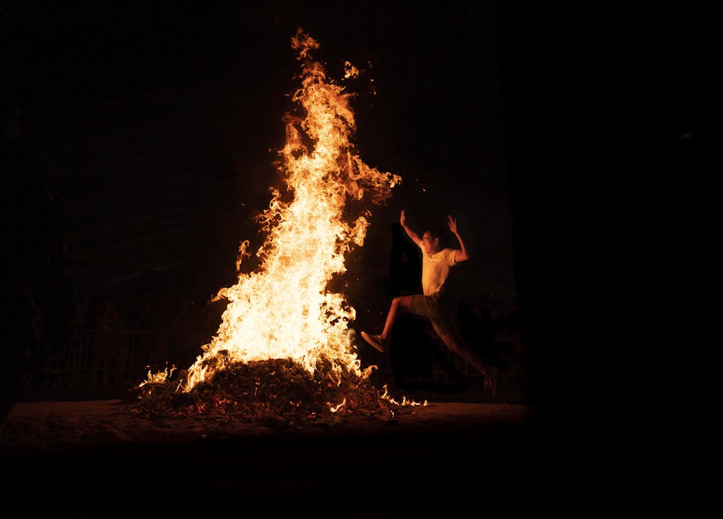 Leaping in front of Bonfire during Nighttime